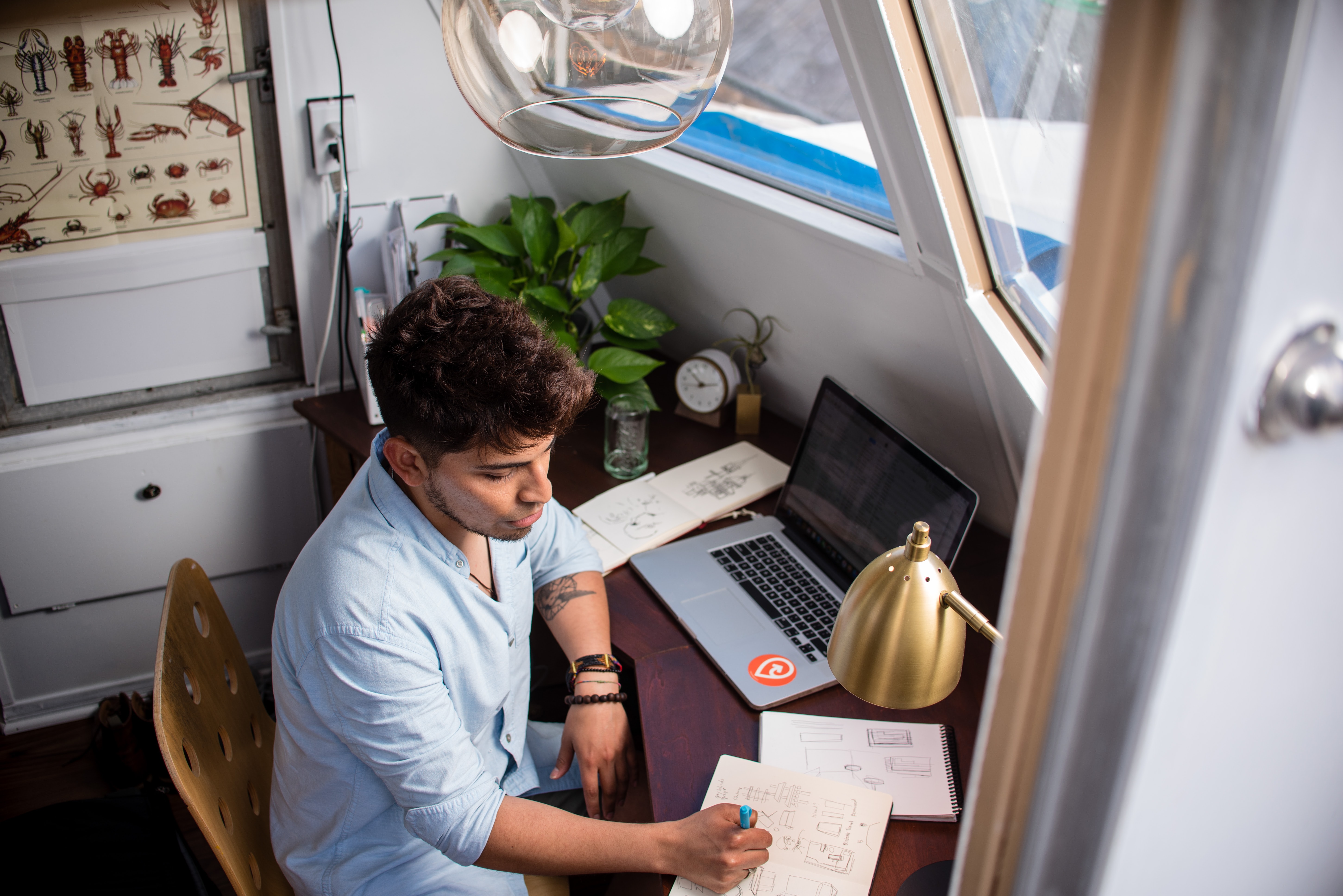 Man sitting at his desk writing in a notebook