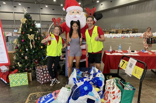 Lexi donating toys and books for children at the Brisbane Convention Centre.