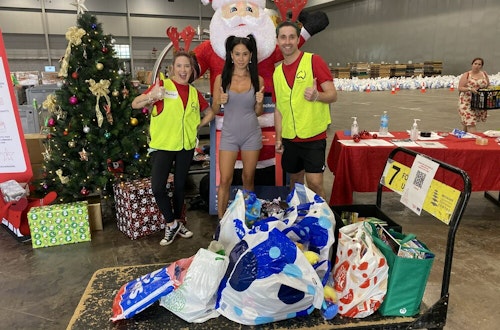 Lexi donating toys and books for children at the Brisbane Convention Centre.