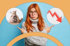 Woman looking sad pointing to a bag of money and a declining arrow