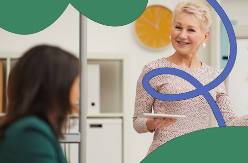 Two women talking in an office, representing compliance training