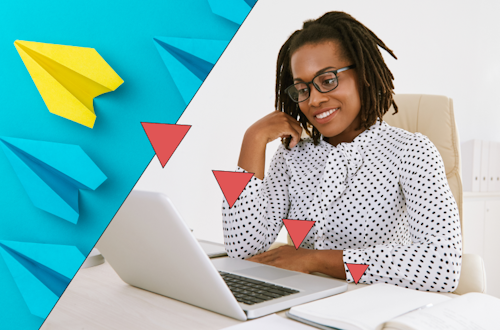 Woman in a dotted black and white blouse sitting at her desk, representing an HR manager overcoming challenges