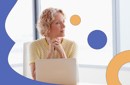 Lady in a yellow shirt sitting contemplatively at her laptop, representing human resources in the healthcare industry 