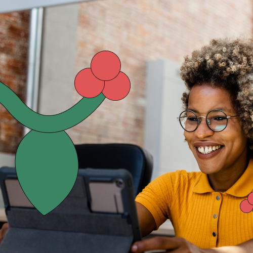 Woman sitting at her desk smiling at an iPad