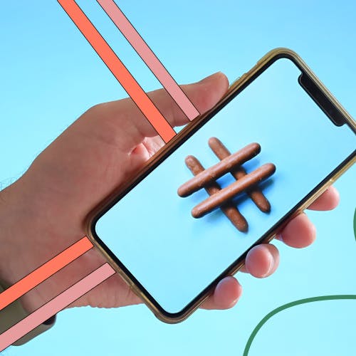 Phone holding an animated phone screen with a hashtag on it to represent L&D trends