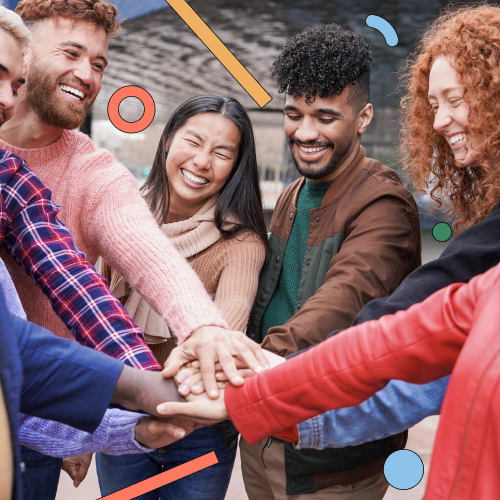 Seven smiling people standing in a circle with their hands in the centre