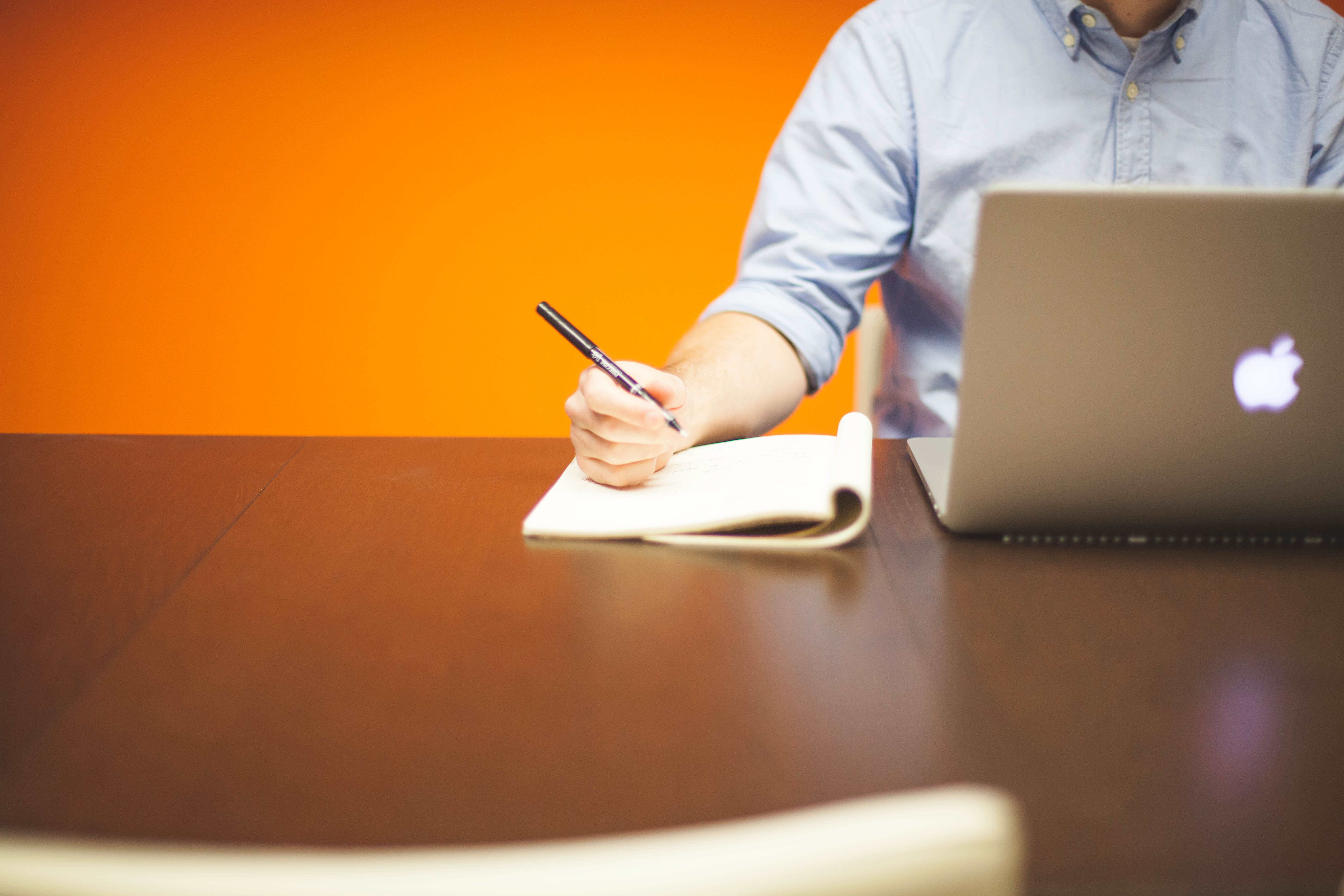 Man writing in a notepad