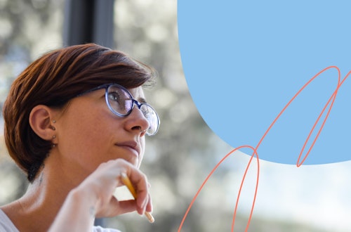 Woman wearing glasses and holding a pencil staring out the window