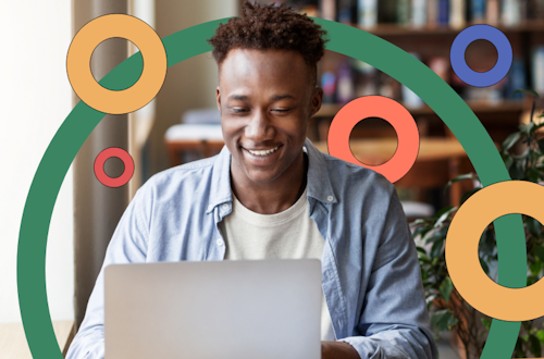 Man smiling and typing on his laptop, representing continuous professional development