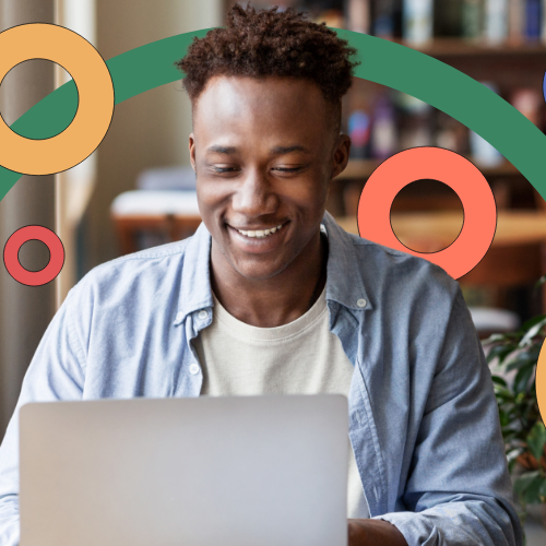 Man smiling and typing on his laptop, representing continuous professional development