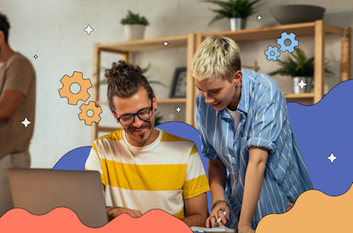 Two people working on a laptop in an office, representing productivity