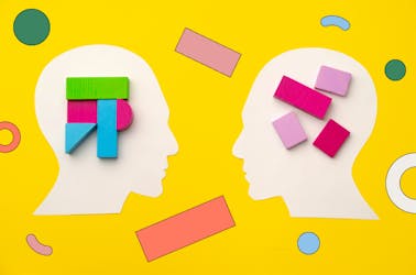 Animated outline of two people's heads, showing different building blocks in their brains