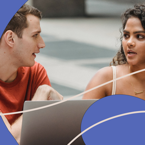 Two young people working together on a laptop