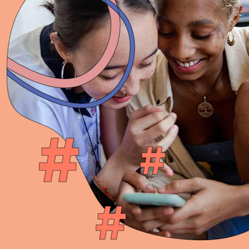 Two young people looking at a phone together and smiling