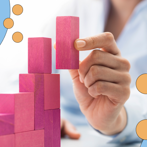 Person stacking blocks in a staircase shape