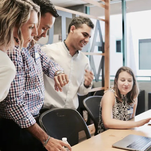 Four colleagues working on a task in the office to symbolise the habit loop