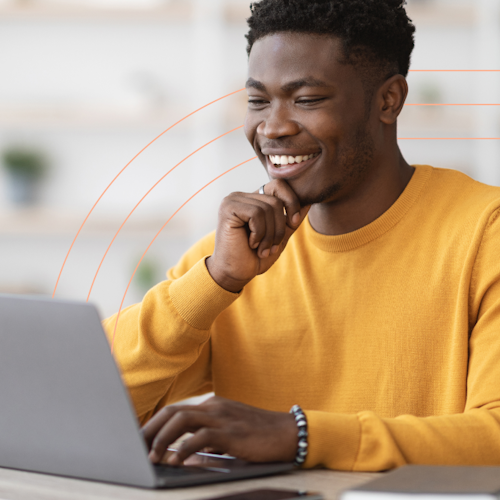 Man working on his laptop and smiling