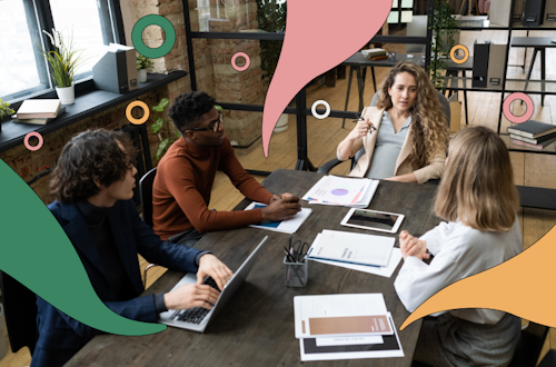 four people sitting around a table working