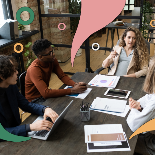 four people sitting around a table working