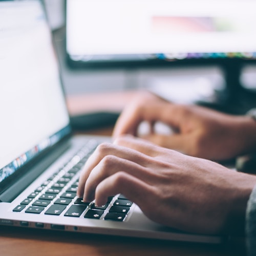 Disembodied hands typing on a keyboard