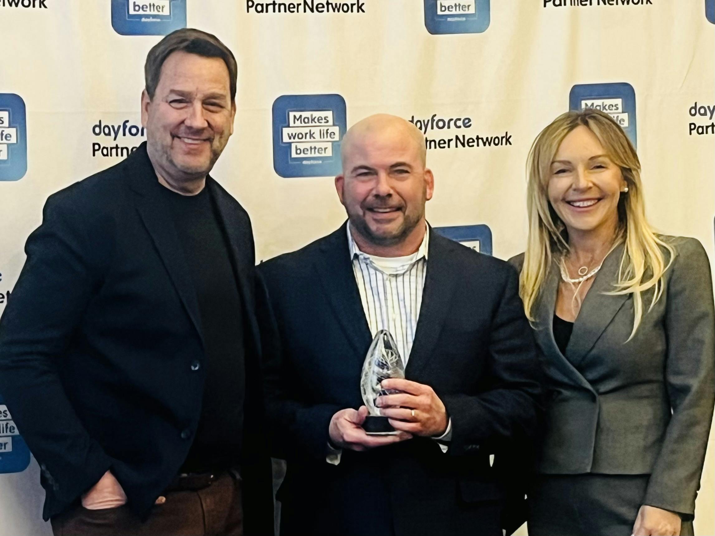 Steve Holdridge, President & COO at Dayforce; John Chevalier, Partner Director at Go1; Beata Reimer, Head of Global Partner Ecosystem at Dayforce pose for photo at Dayforce Award ceremony