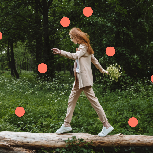 Image of adult balancing on log in forest