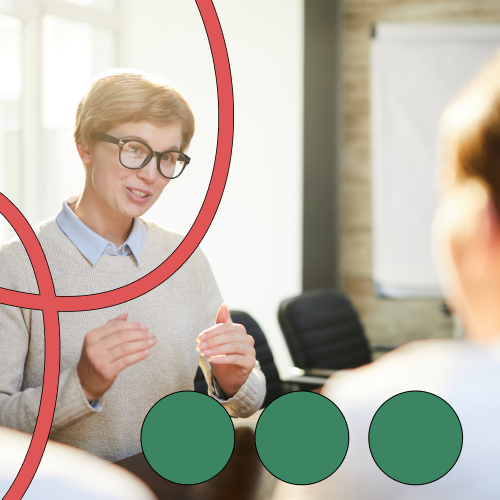 Woman wearing black glasses speaking in a meeting