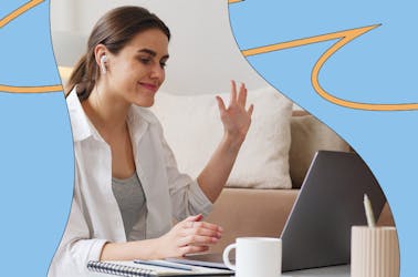 Woman on a call waving at laptop screen