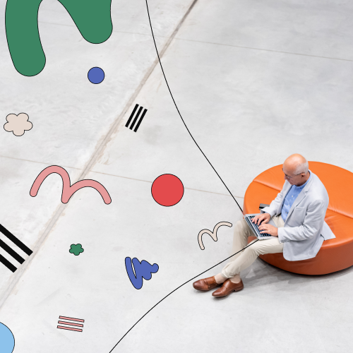 Man working on a laptop surrounded by abstract design, representing content aggregation