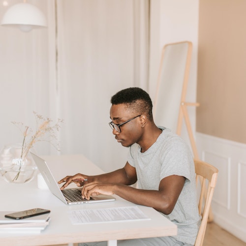 Man sitting in his home office and typing