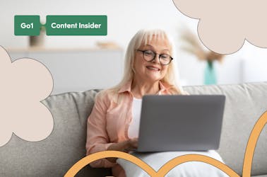 Older woman sitting on the couch using her laptop