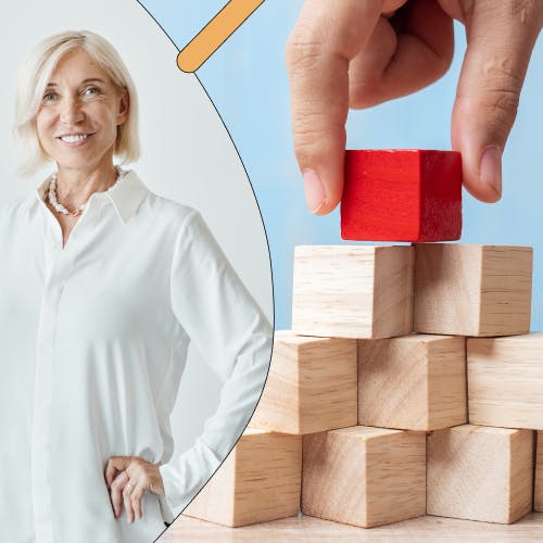 Woman standing with her hands on her hips, next to a pyramid with a red cube on top, representing self-leadership