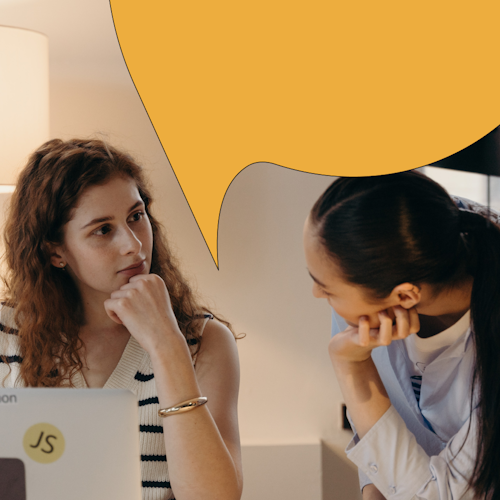 Two women working together on a computer