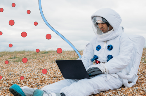 Man in astronaut suit with laptop