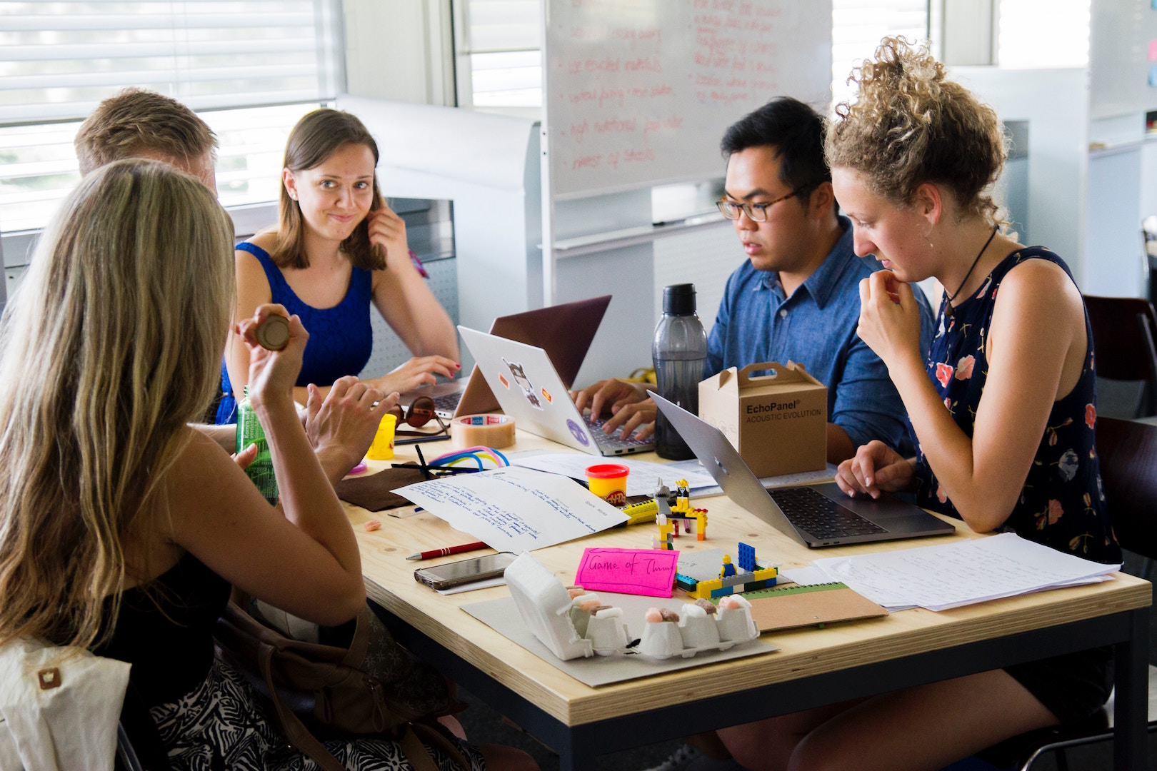 A diverse group of people sitting around a table in an office setting