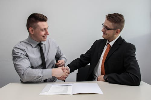 Two businessmen shaking hands after a job interview.