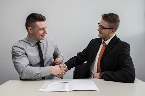 Two businessmen shaking hands after a job interview. 