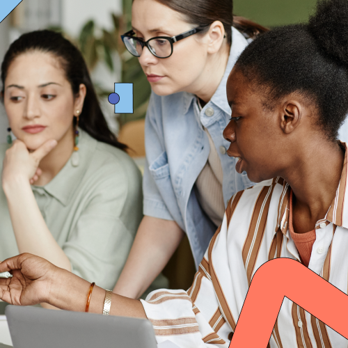 Four people sitting at a table looking at a screen