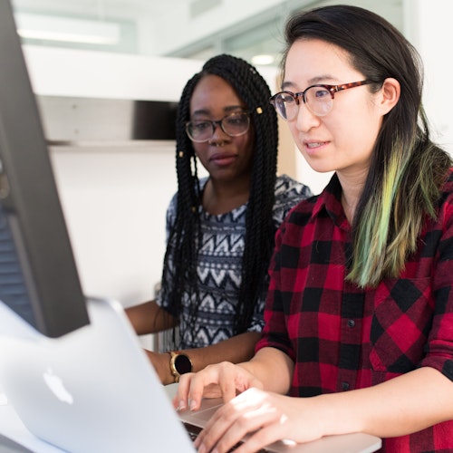 Two people collaborating at a laptop, representing engagement tools 