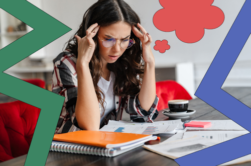 Woman looking confused and frustrated while reading a textbook, representing barriers to learning at work