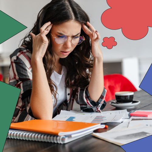 Woman looking confused and frustrated while reading a textbook, representing barriers to learning at work