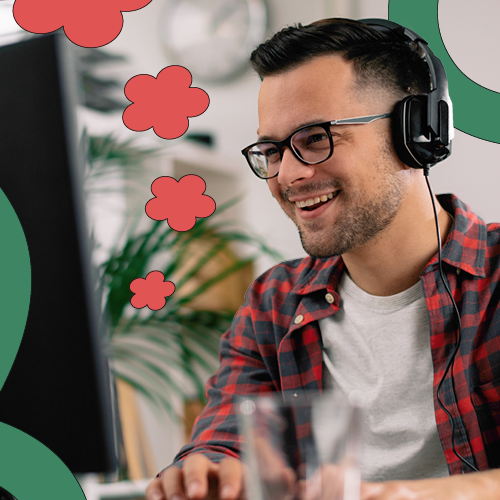 Man smiling and working on his laptop