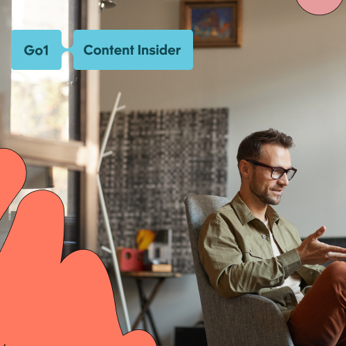 Man sitting casually gesturing hand at laptop