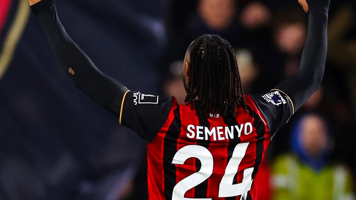 Antoine Semenyo raises his arms in triumph while wearing his Bournemouth jersey, with his name and number 24 visible from the back.