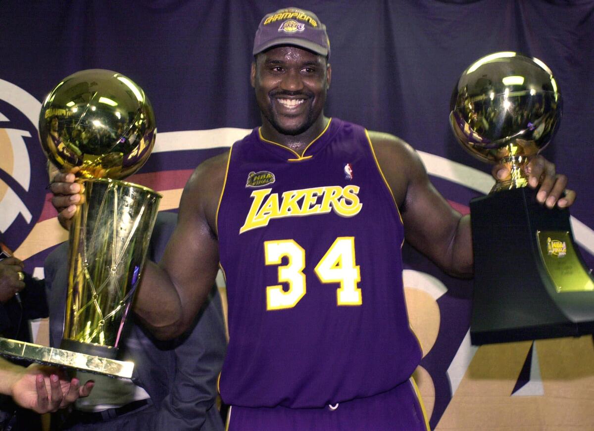 Shaq with his Championship and Finals MVP trophy