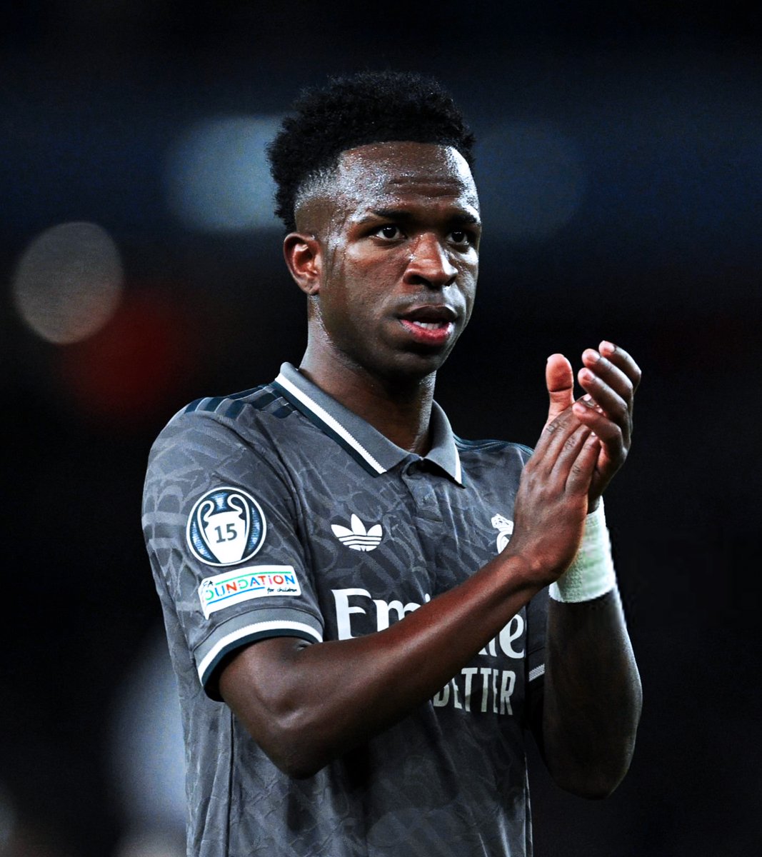 Real Madrid forward Vinícius Júnior applauding during a match