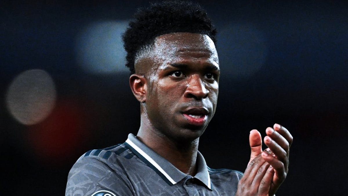 Real Madrid forward Vinícius Júnior applauding during a match