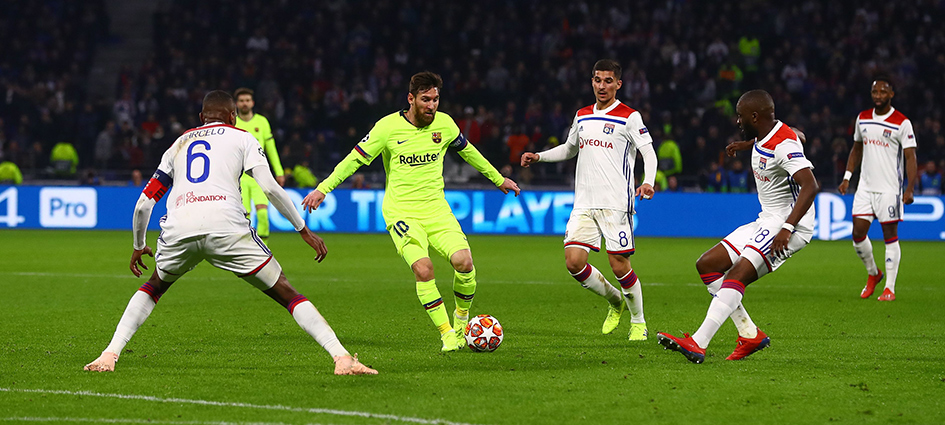 Messi surrounded by opponent players