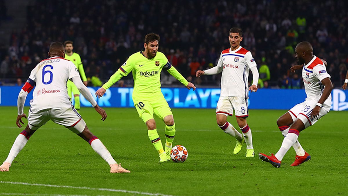 Messi surrounded by opponent players