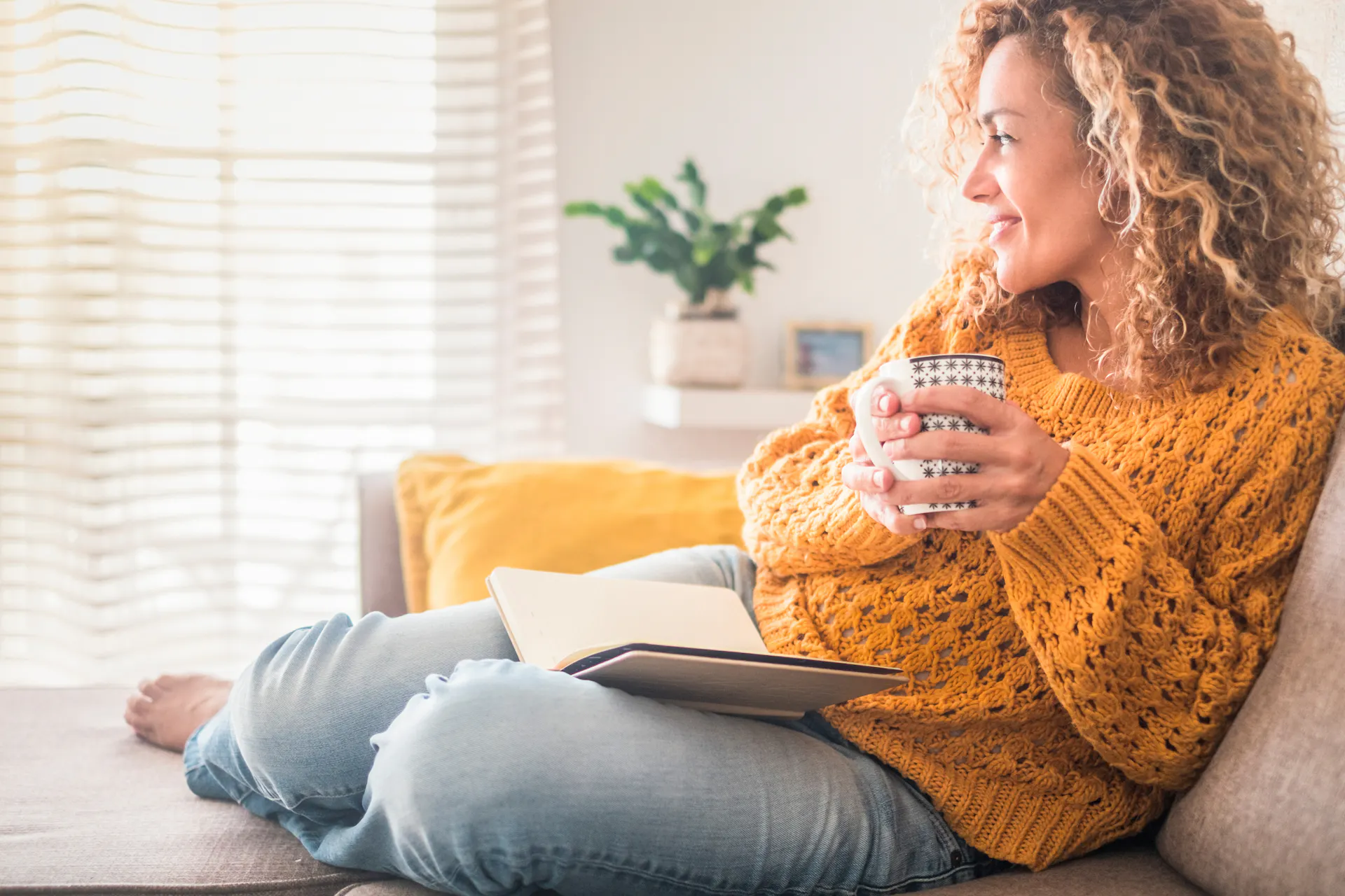 Woman sitting on couch with a cup of tea